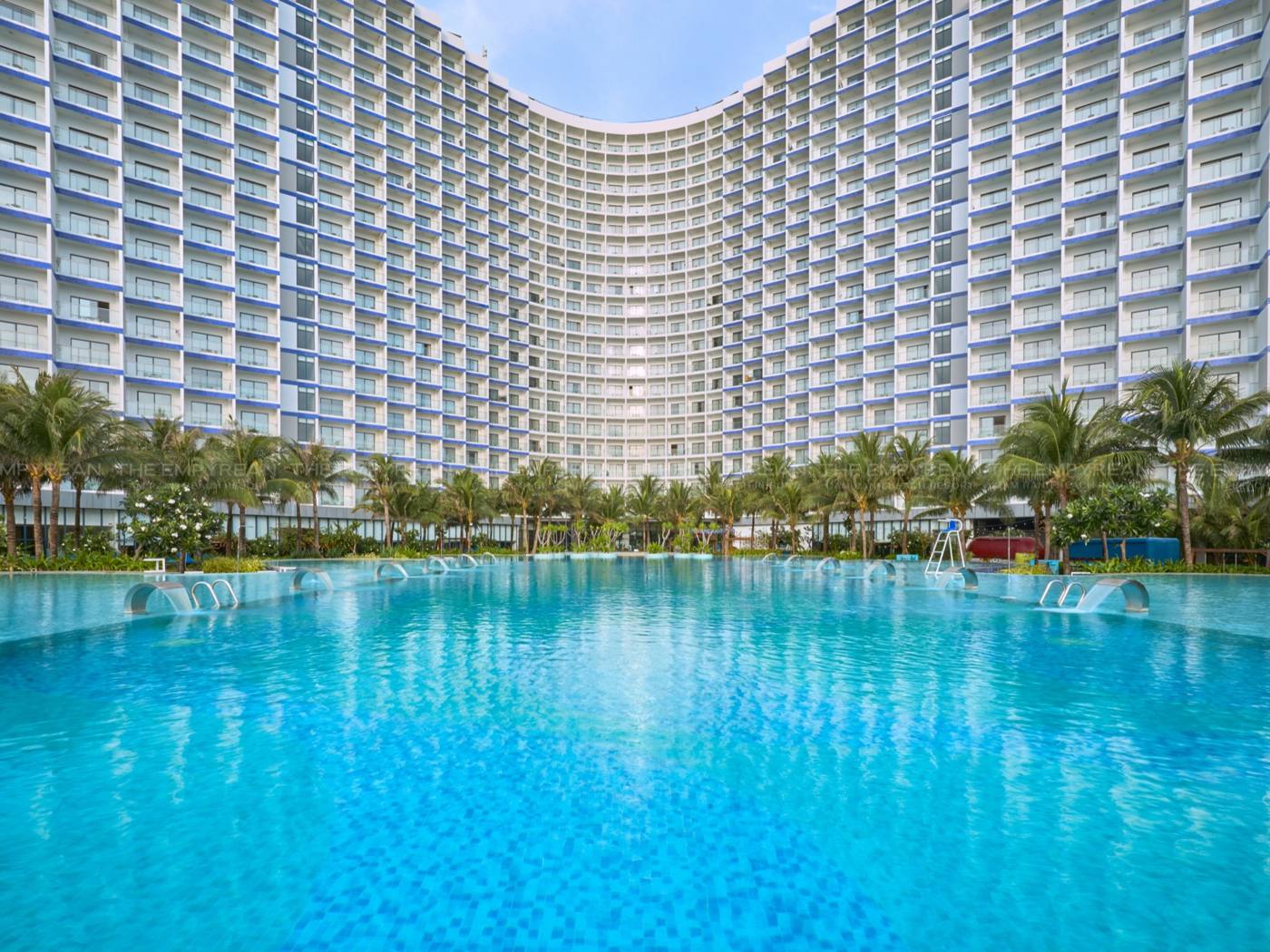 Long blue pool in front of the resort towers